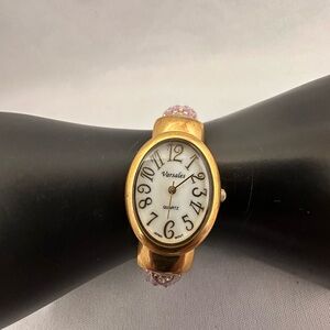 Varsales gold tone and lavender clamper watch
